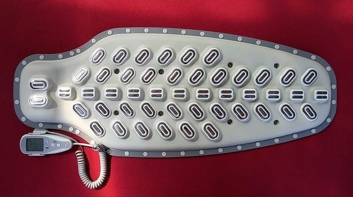 Vertebra microcurrent biofeedback full body application with remote on red background