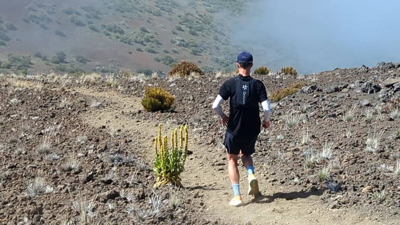 Mauna Kea 10k feet elevation, man running down into mists